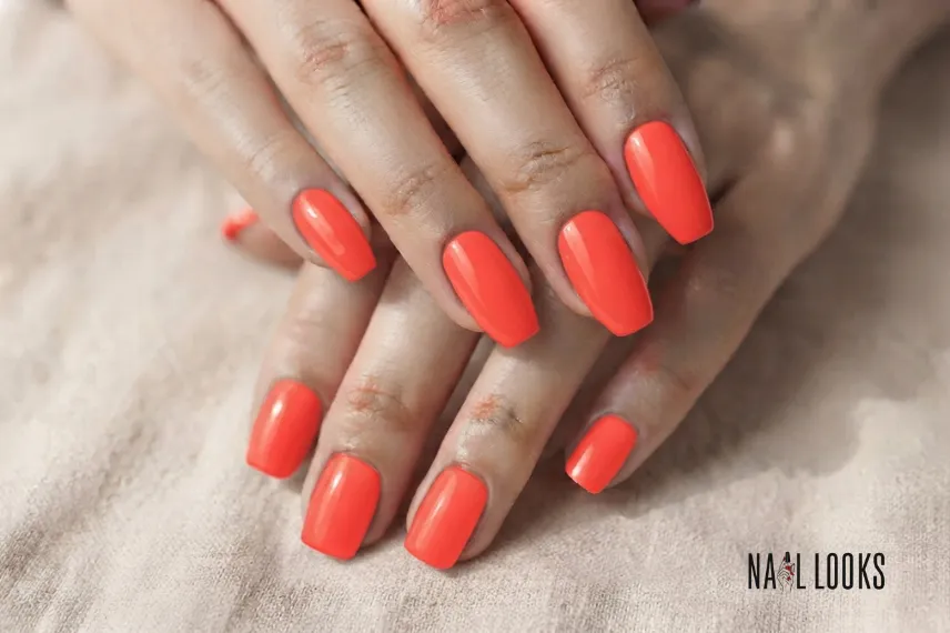 Bright coral red on almond nails